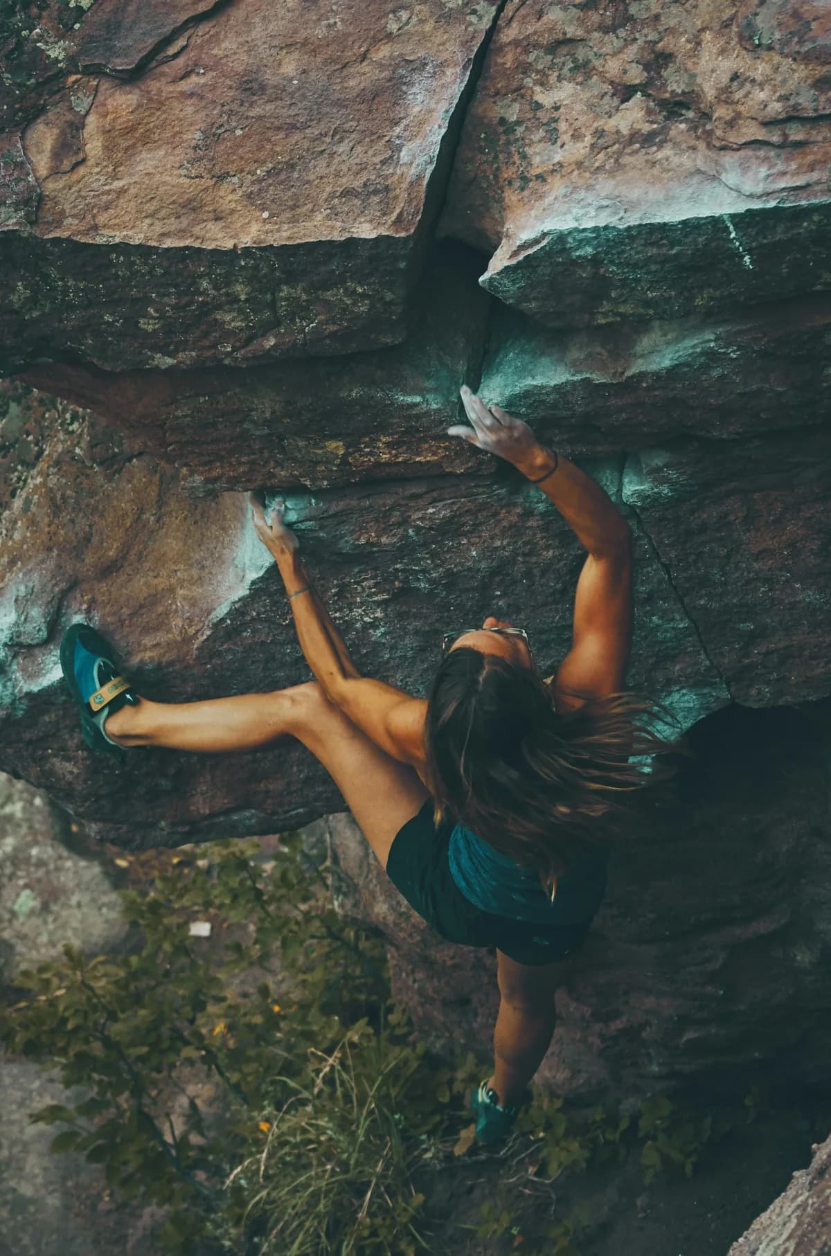 Rock climber reaching for a hold mid-route, illustrating chiropractic support for athletic performance in Oceanside