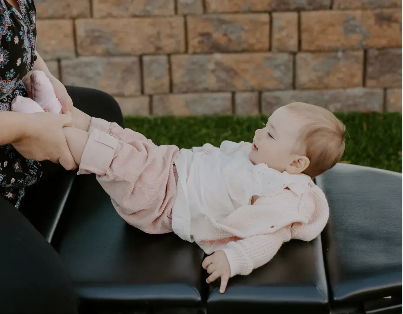 Oceanside chiropractor providing gentle pediatric chiropractic care, supporting a calm baby during a light adjustment