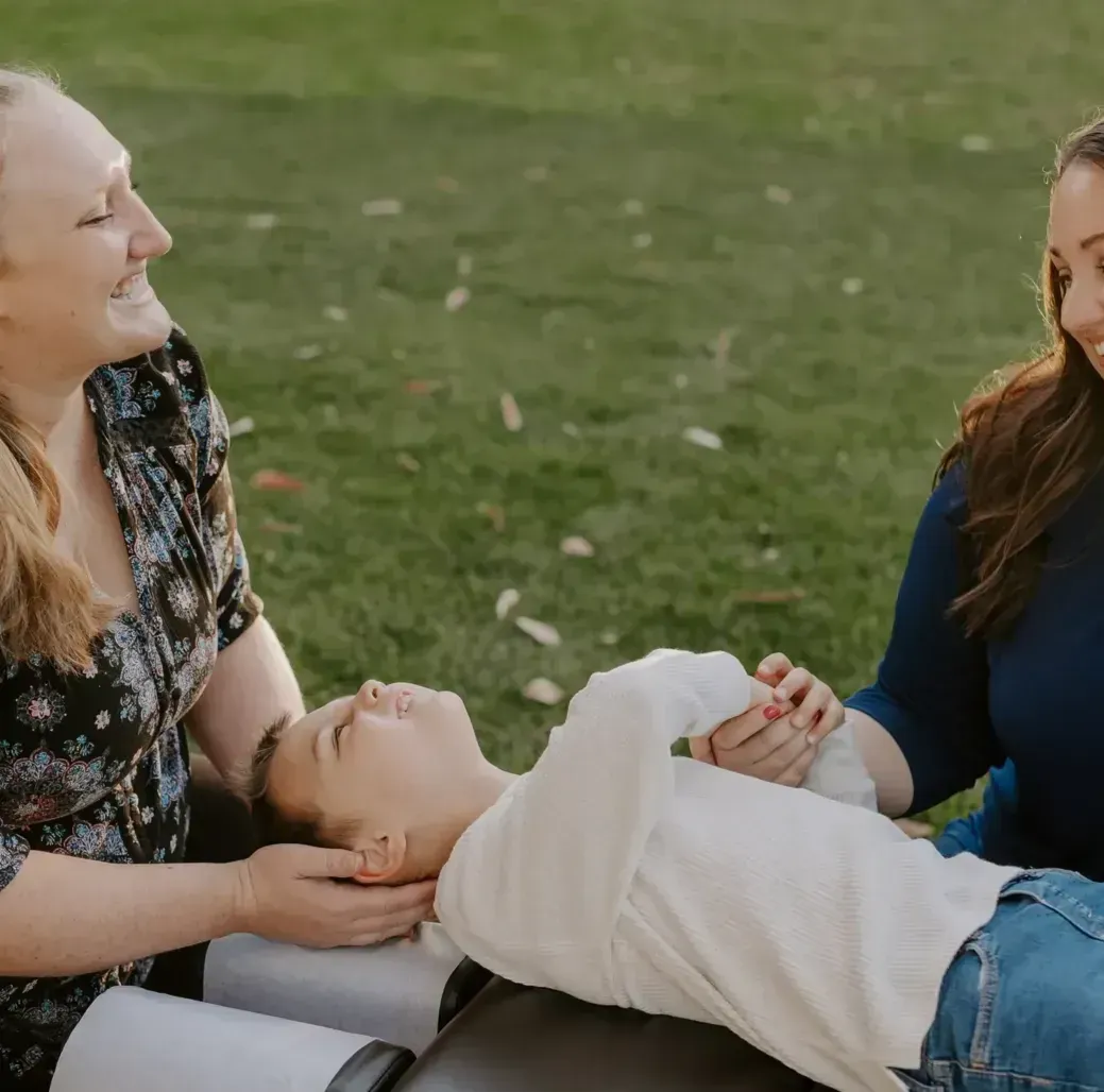 Dr. Caitlin Walker gently supporting a patient's head and neck during low-force care in Oceanside