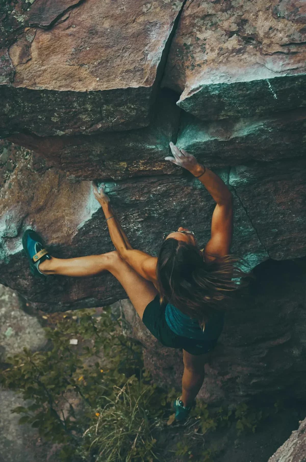 Rock climber on a boulder, representing sports performance care from an Oceanside chiropractor