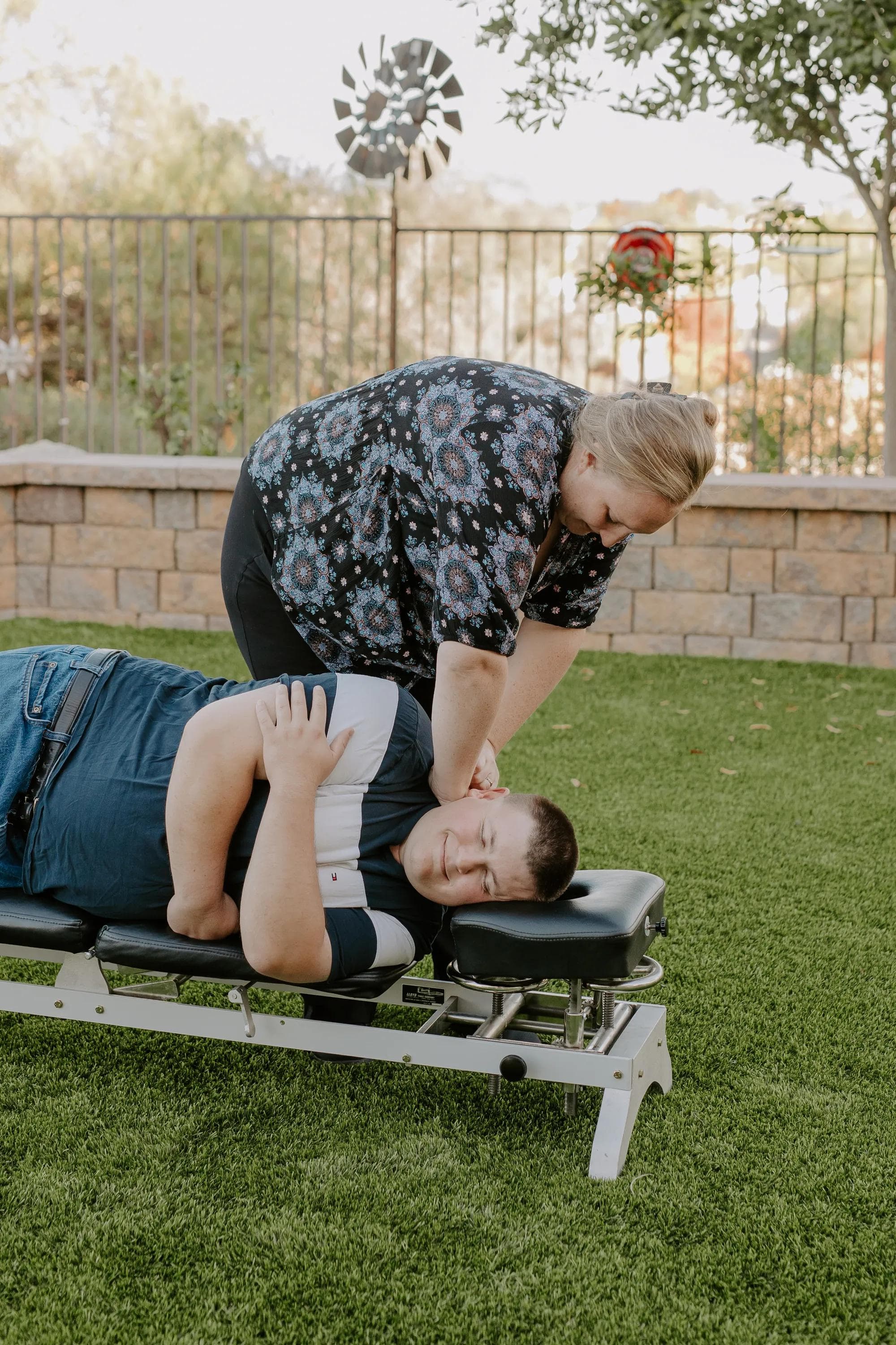 Dr. Walker's hands contacting the full length of a patient's neck during a gentle Blair adjustment in Oceanside