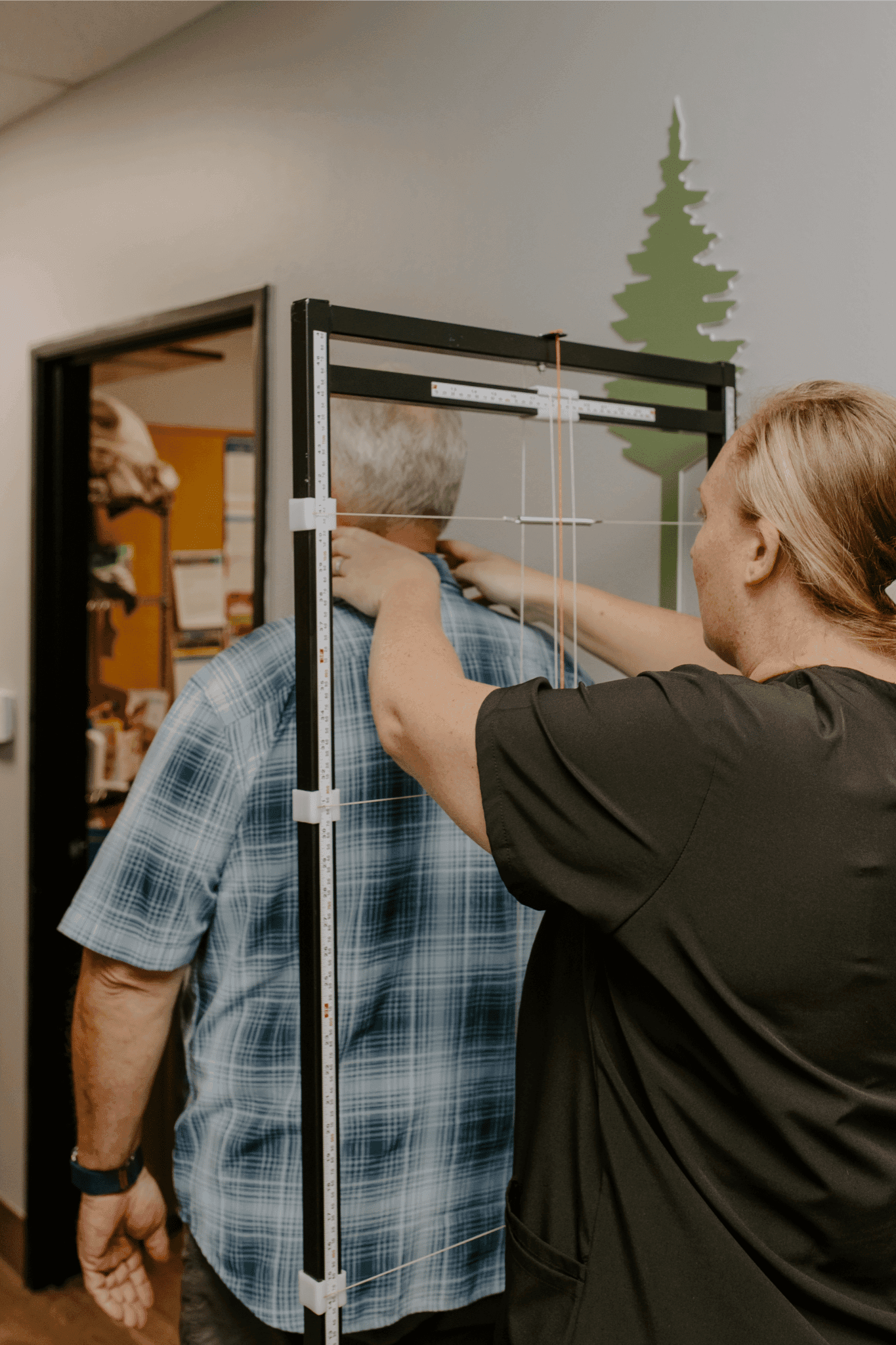 Oceanside chiropractor Dr. Caitlin Walker giving an older patient a targeted and gentle alignment
