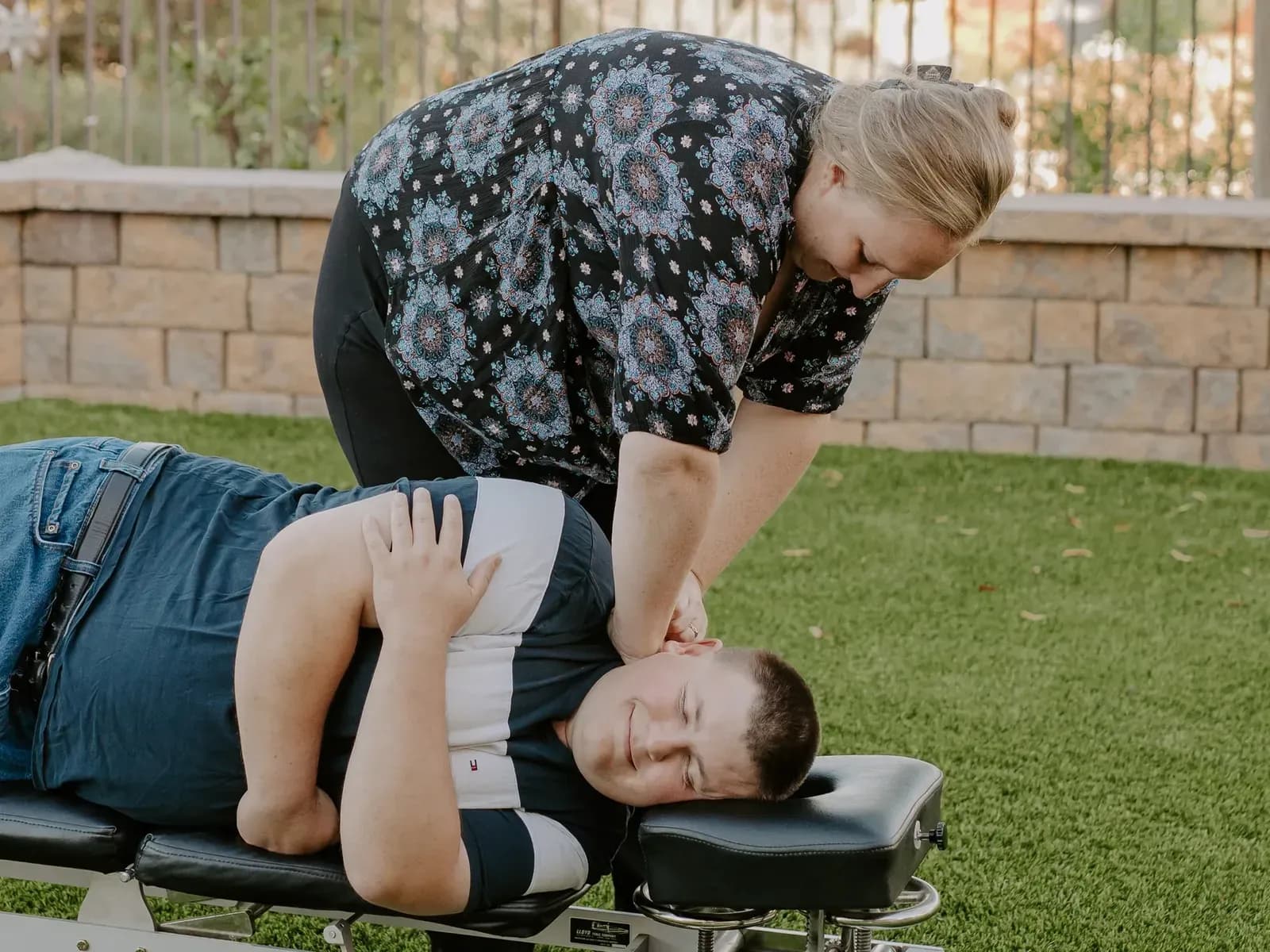 Dr. Caitlin Walker giving a gentle adjustment to a patient lying on his side at an Oceanside chiropractic visit