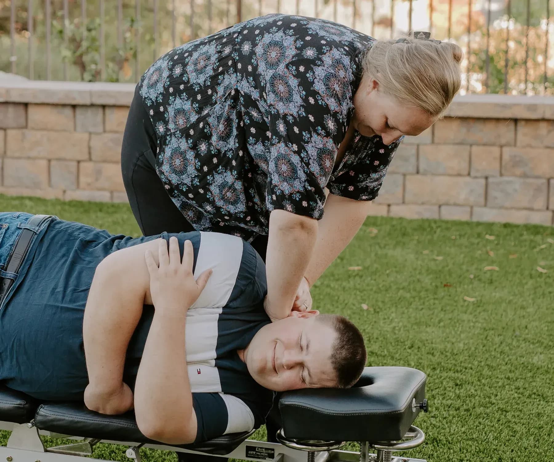 Dr. Caitlin Walker giving a gentle side-lying upper cervical adjustment as part of neck pain care