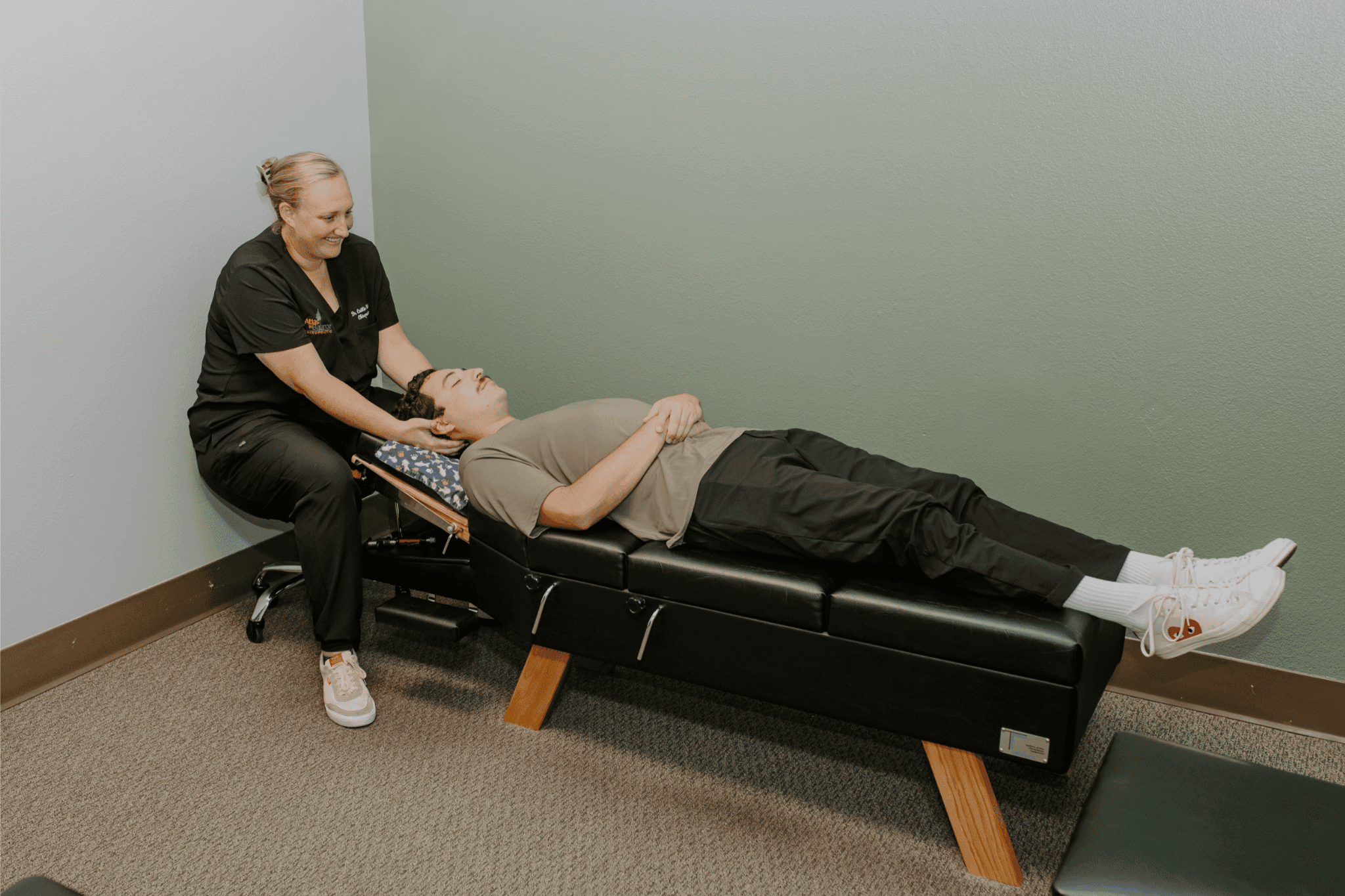 Oceanside chiropractor Dr. Caitlin Walker cradling a patient's head during a Blair upper cervical check